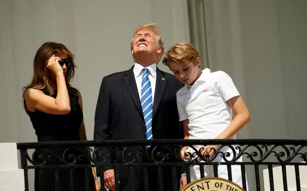 US-President-Trump-and-family-watch-the-solar-eclipse-from-the-White-House-in-Washington.jpg