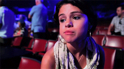 Selena-Gomez-Shrugs-It-Off-While-Eating-An-Apple.gif